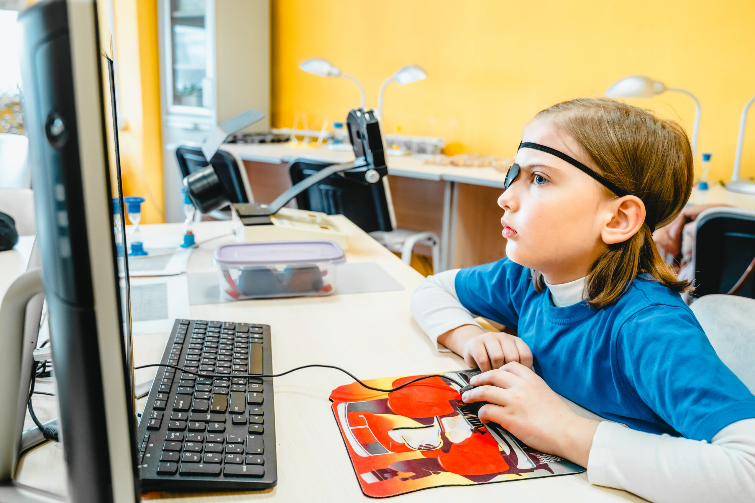 Little girl in medical office undergoing advanced laser vision treatment, correction for eyes health. Pediatric ophthalmology procedure. Visual acuity, strabismus improvement. Advanced technology